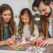 Family of three, two adults and a child, working together on a puzzle.