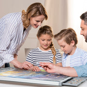 Family of four working on a puzzle together.