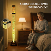 Woman reading a book in a bedroom with a bubble light.